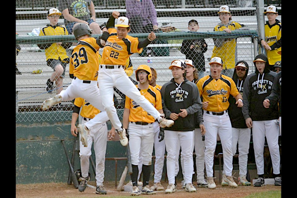 Austin Gurney (left) and Thomas Soto celebrate after Gurney’s fifth home run of the season on Friday night against Sylvan Lake.