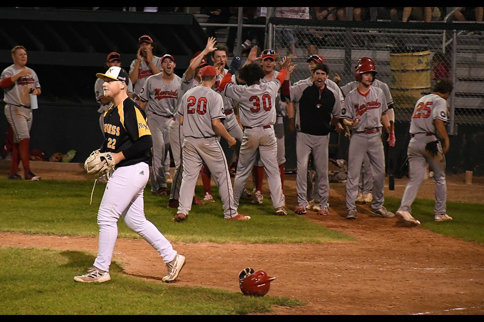 Medicine Hat celebrates their go-ahead run as Reece Helland returns to the mound to finish the ninth inning.