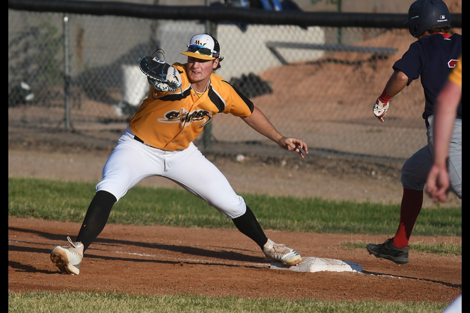 Hudson Barrett hauls in a throw from shortstop Zach Campbell for an out at first.