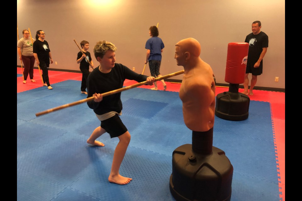 A member of the Kim's Taekwondo bojutsu class works on his technique.