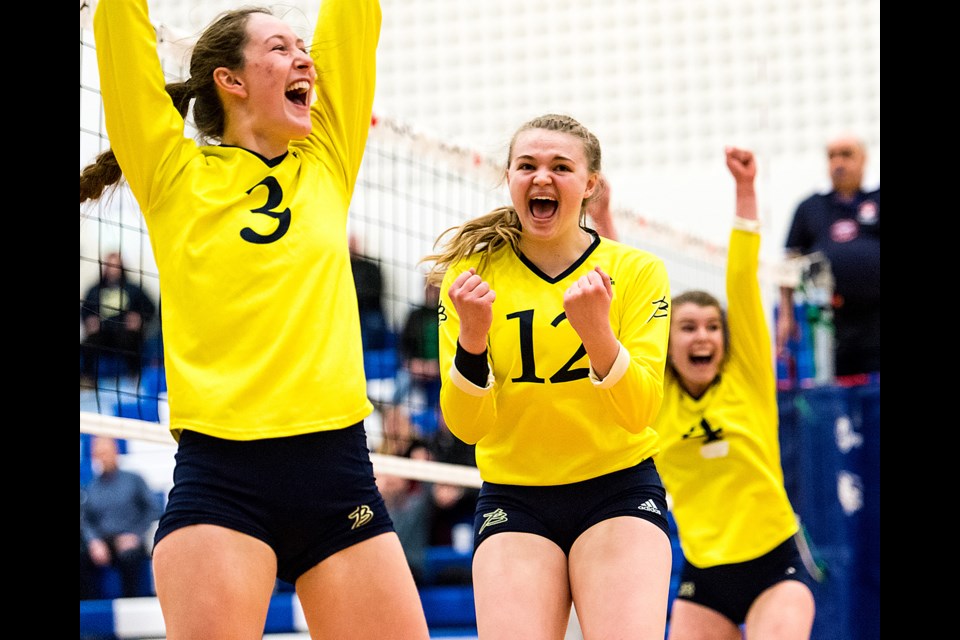 Briercrest College Clippers Becky Garner (left), Faith Buhler and Kirsty Kindrachuk celebrate a point during Saturday's bronze semifinal. Ryan McCullough/CCAAsportACSC