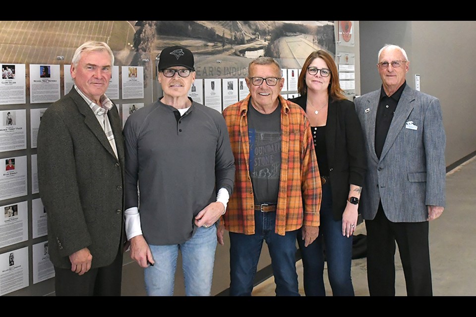 Members of the Moose Jaw and District Sports Hall of Fame board and sponsor JGL join Brian Montague (second from left) and Ken Bradley (right) for a photo at the Hall of Fame announcement on Thursday.