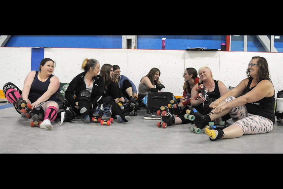 Members of the Moose Jaw Derby Guild put on their skates during their meet-and-greet on Monday at Red Knight Arena.