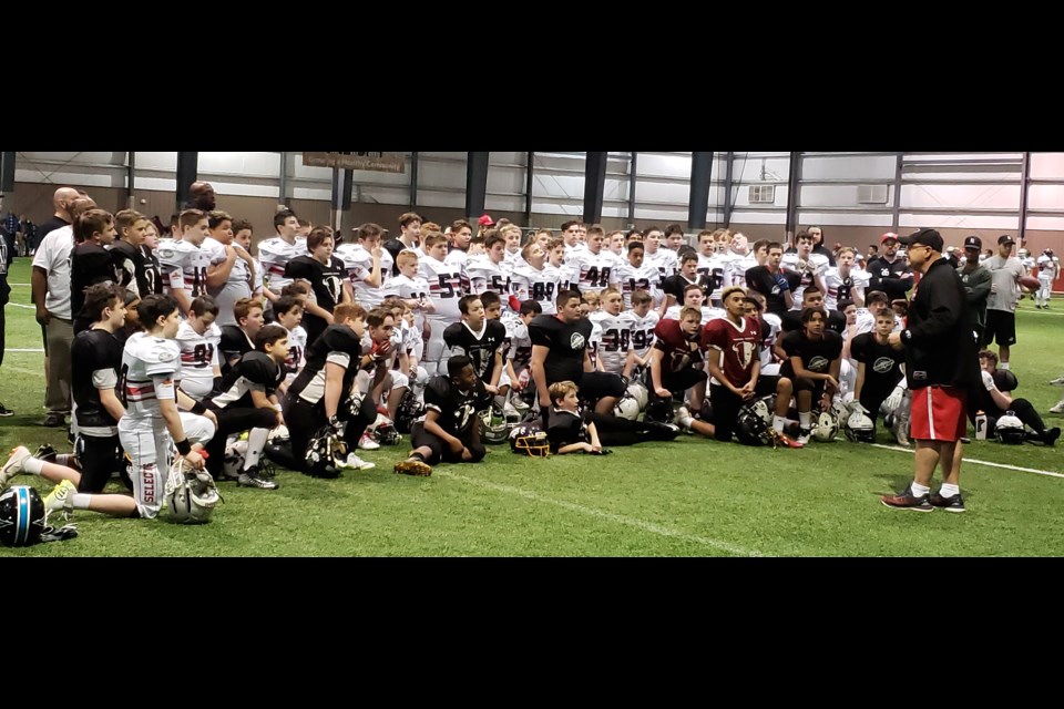 The Saskatchewan Selects and their Manitoba counterparts listen to a post-game presentation from organizer Zeljko Stefanovic. Randy Palmer photograph