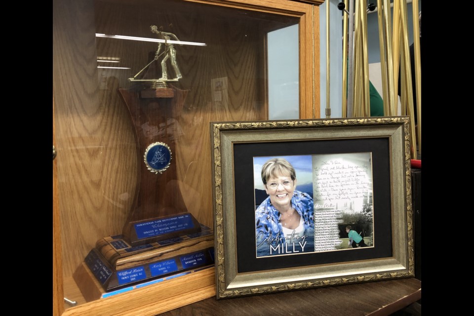 A memorial picture of Mildred (Milly) Schultz sits next to the championship trophy. Photo by Jason G. Antonio 