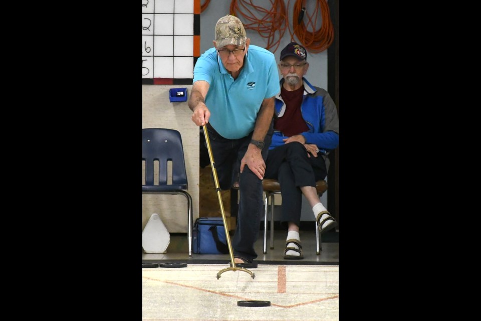 Rick Schultz delivers a shot during the championship final.