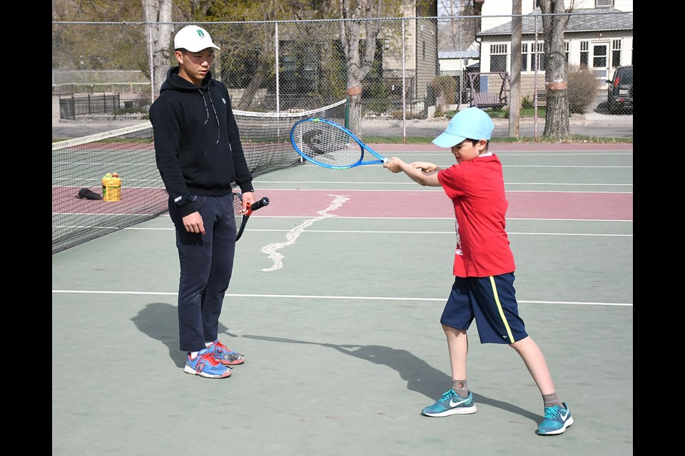 Provincial team member Harry Lin offers a few forehand tips to Franco Pecorari during a lession at the Moose Jaw Tennis Club last season