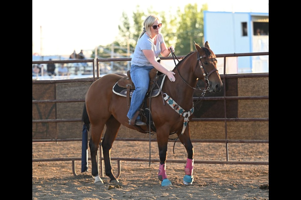 A rider gives her horse a few pats of encouragement as they wait to compete. MJ Independent photo