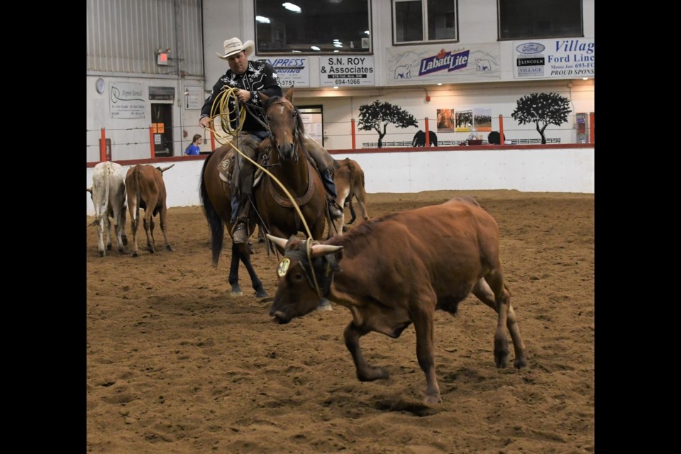 Kelsey Elford manages to rope his cow.