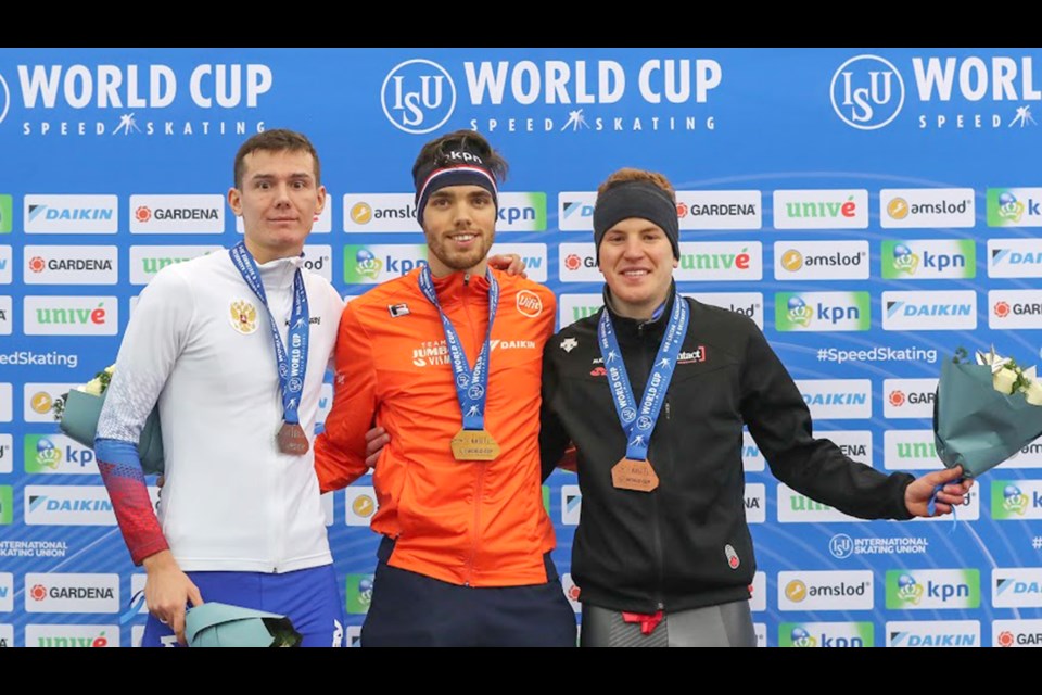 Danila Semerikov of Russia, Patrick Roest of the Netherlands and Graeme Fish of Canada pose on podium after the medal ceremony. Photo by Christian Kaspar-Bartke / International Skating Union