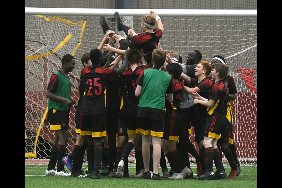 The Central Cyclones hoist Landon Meacher into the air as they celebrate their provincial soccer championship.