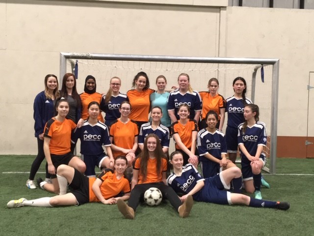 Moose Jaw U17 girls in orange and U19s in blue, with coaches Kelsey Segall and Alysha Evans. Photo by John Morris