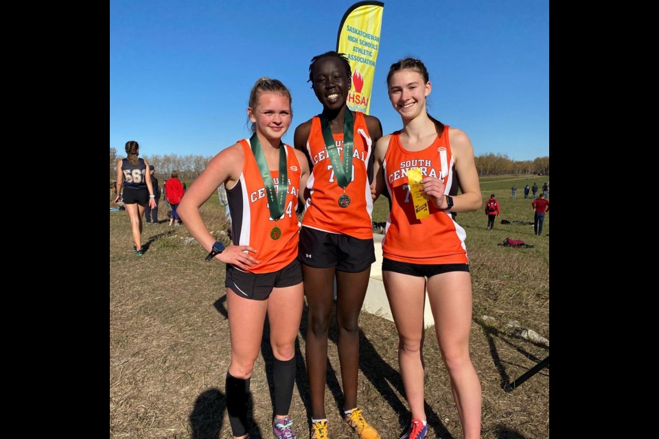 SHSAA senior girls cross country gold medalist Jadyn Palaschuk (left) pauses for a photo with fellow Central runner and second-place finisher Akuol Riak and fifth-place finisher Brooklyn Roney of Peacock.