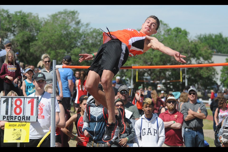Zidane Closs attempts to clear 1.81 metres during the midget boys high jump