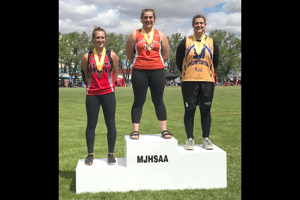 Vanier’s Delaney Townsend on the podium after receiving her senior girls javelin gold medal.