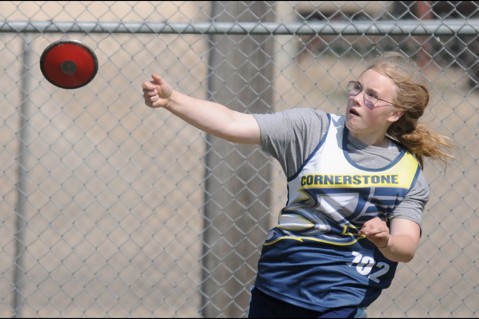 Cornerstone Christian School's Aliyah Block competes in the midget girls discus after setting a new district record in the shot put.