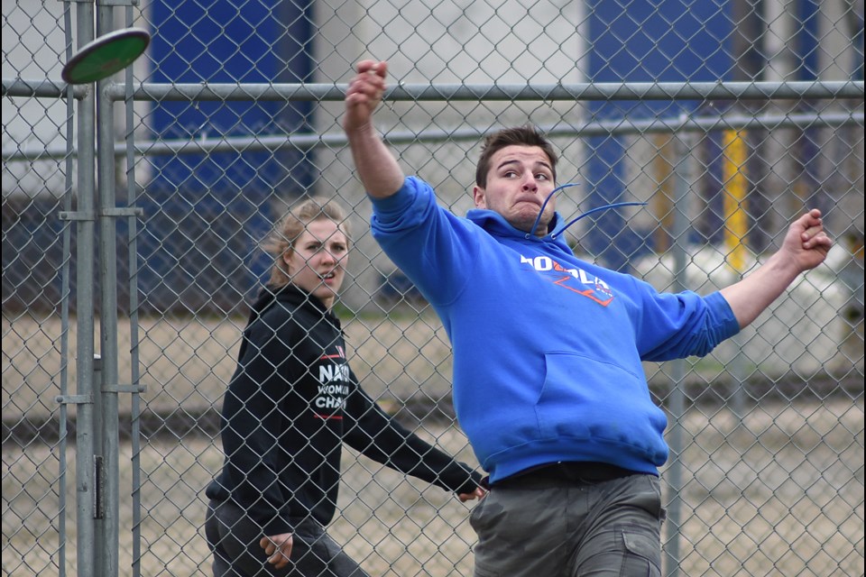 Weyburn’s Alex Lund unloads a throw in the junior boys discus as a fellow competitor looks on. Lund would win the event with a 34.74 metre effort.