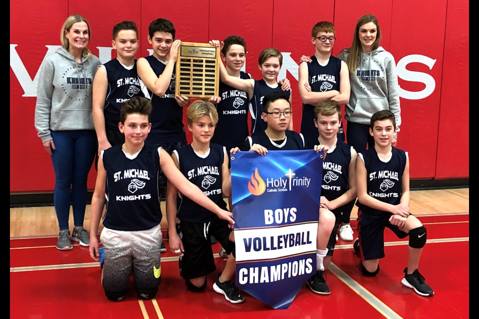 The St. Michael Knights gather for a team photo after winning the Holy Trinity boys volleyball championship.