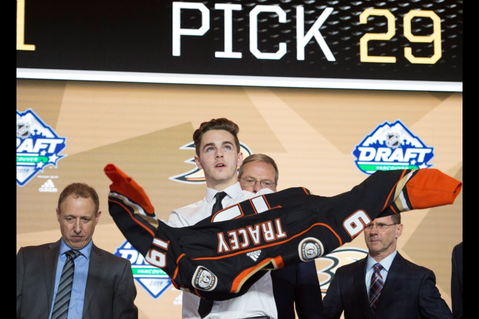 Moose Jaw Warriors forward Brayden Tracey puts on the Anaheim Ducks jersey for the first time. Canadian Press photo