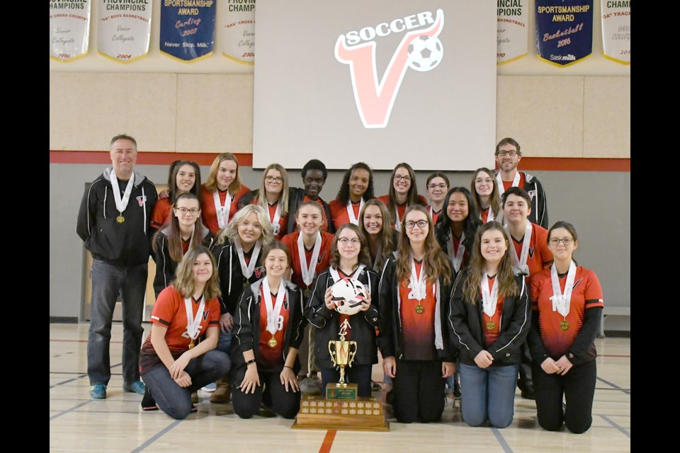 The Vanier Spirits high school girls soccer team pose with their 4A provincial championship trophy after a school assembly congratulating them on their win.