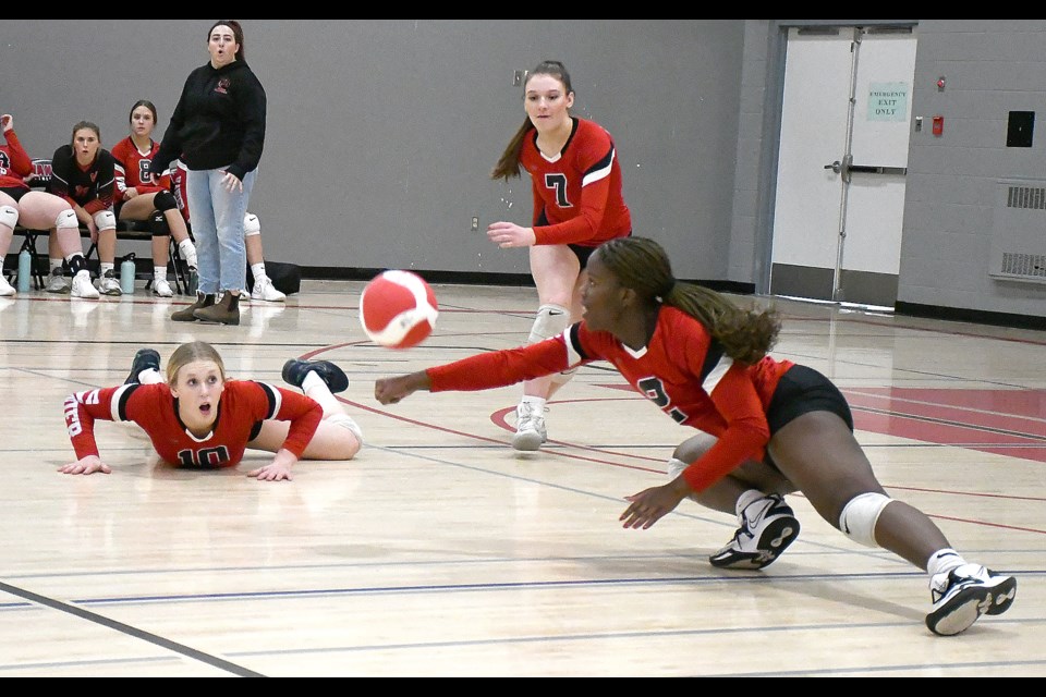 Vanier’s Savana Lynch gets her arm on the ball for a fantastic dig as Haily Molde (10) and Kelsey Moran (7) look on.