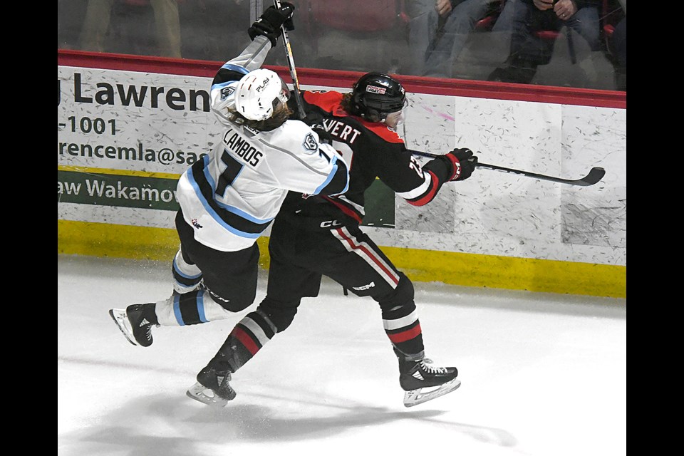 Warriors forward Atley Calvert lays a huge hit on Winnipeg captain Carson Lambos.