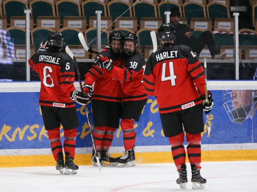 Brayden Tracey of the Moose Jaw Warriors (7) celebrates with Connor Zary (18), Jamie Drysdale and Thomas Harley after scoring against Switzerland. Photo by Chris Tanouye/HHOF-IIHF Images.