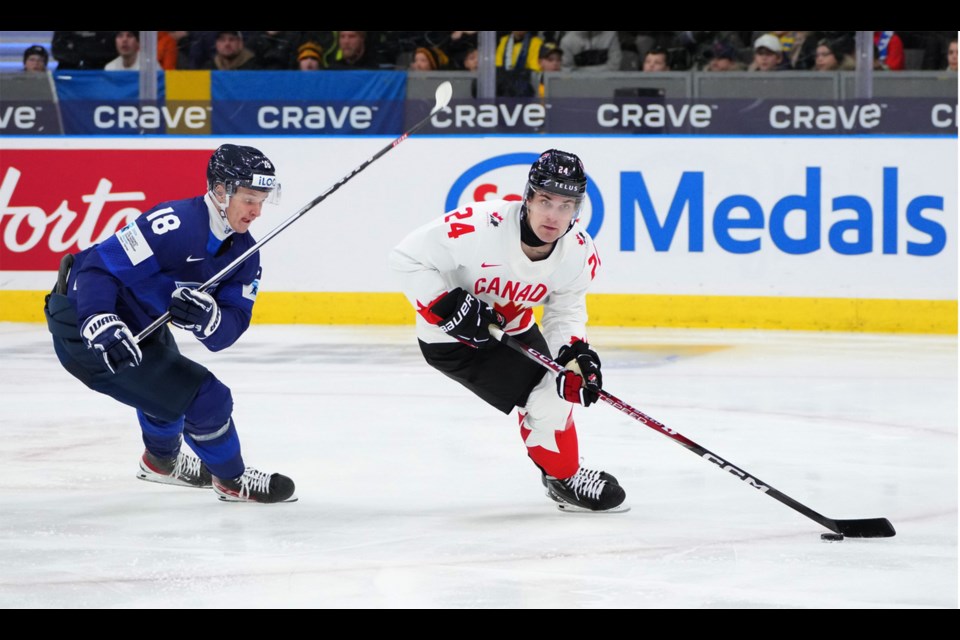 Moose Jaw Warriors defenceman Denton Mateychuk moves the puck away from Finland’s Konsta Helenius during first-period action.