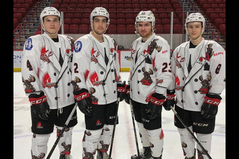 The front view of the Don Cherry-themed jerseys. From left to right: Jett Woo, Josh Brook, Tristin Langan, and Justin Almeida. (Moose Jaw Warriors photo)