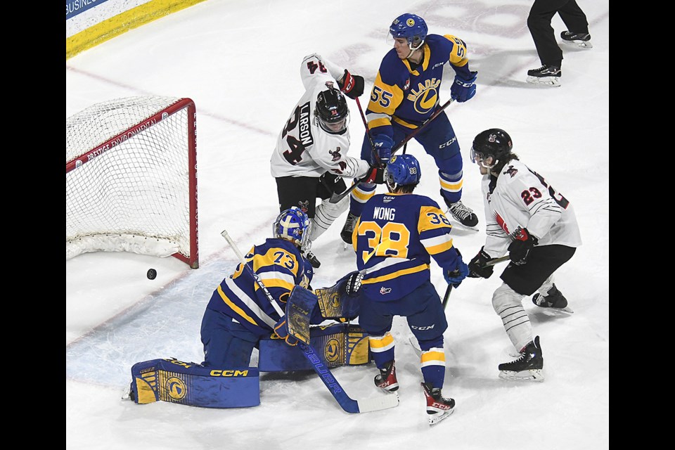 Atley Calvert (23) looks on as his tip in front of net crosses the goalline for the first goal of the series