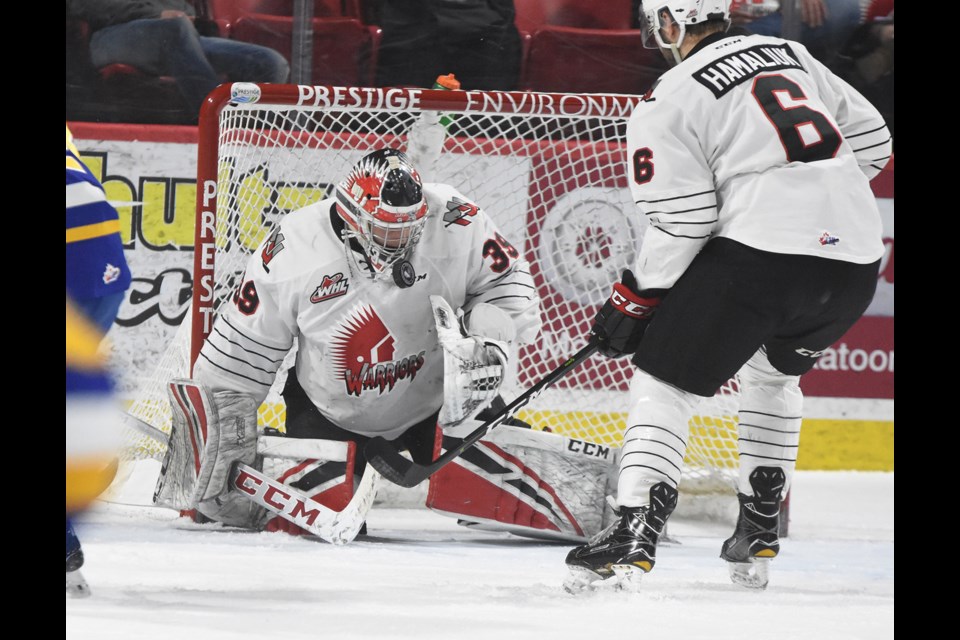 Adam Evanoff turns aside a shot for the Warriors as Dalton Hamaliuk watches for a rebound