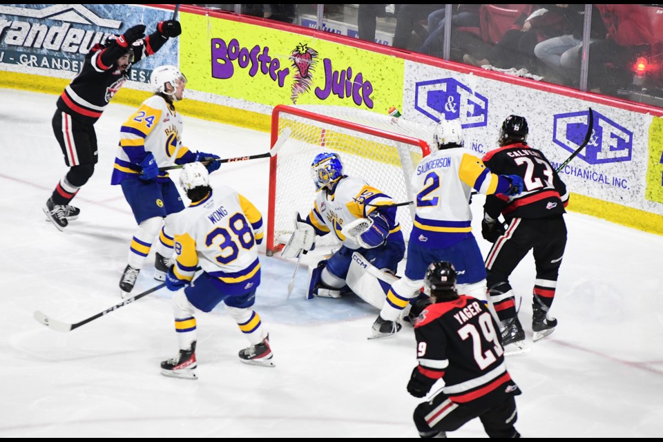 The Warriors celebrate after Atley Calvert scored the game-tying goal in the second period.