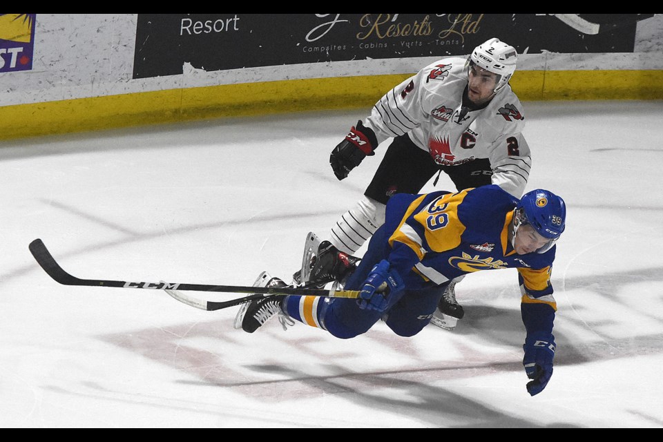 Warriors captain Josh Brook knocks Saskatoon's Riley McKay to the ice during first period action from Game 4.