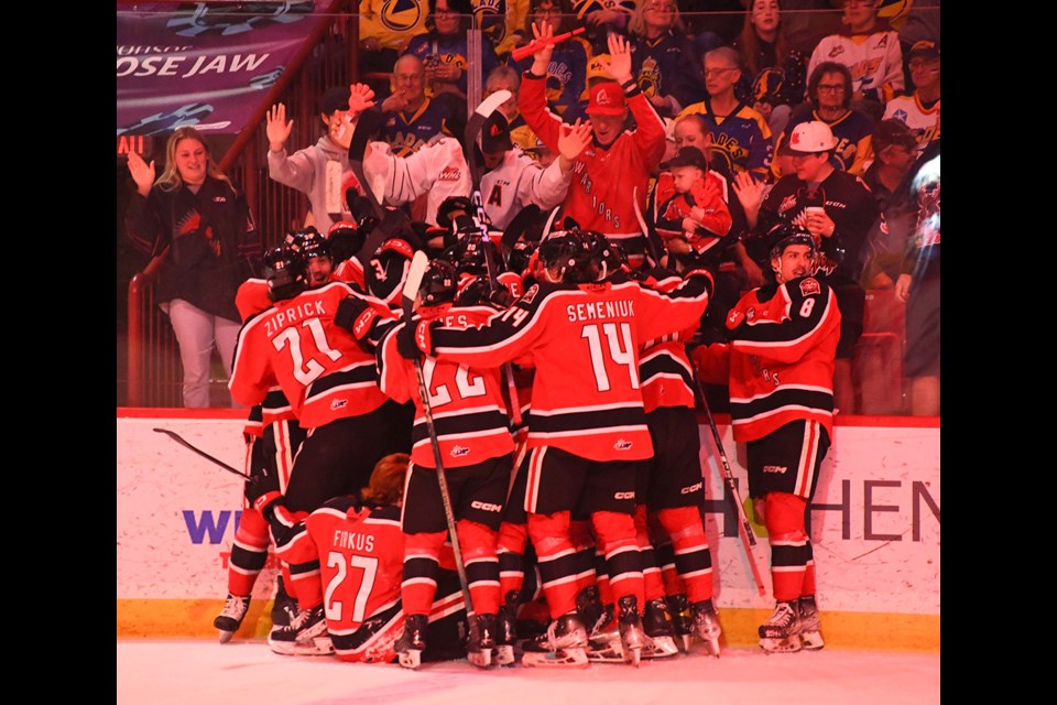 The Moose Jaw Warriors celebrate after winning Game 6 in overtime.