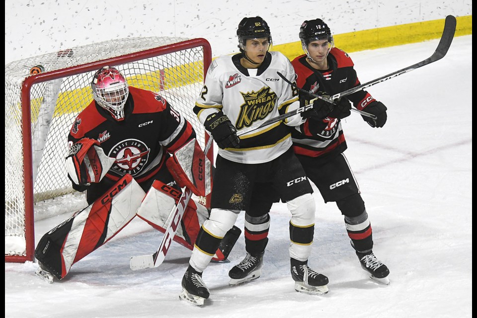 The Warriors’ Cosmo Wilson and Brandon’s Dominik Petr battle for position in front of Jackson Unger.