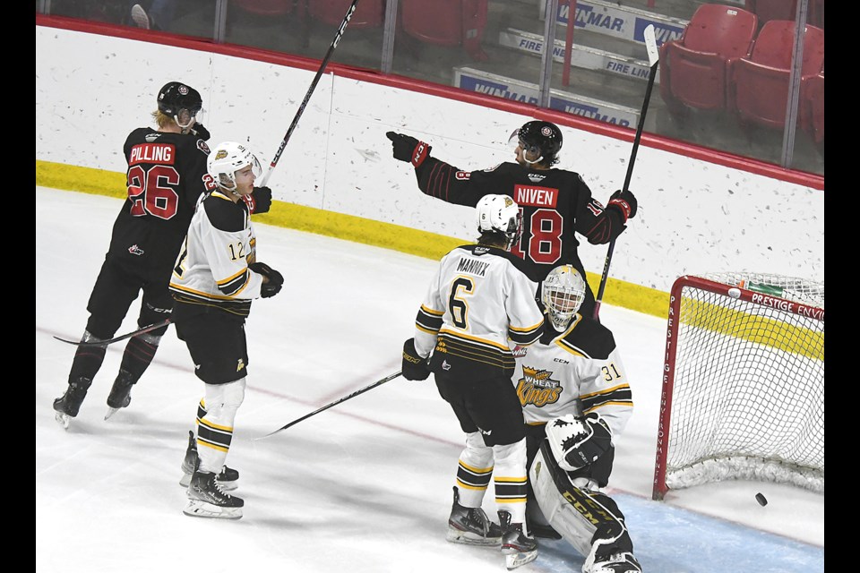 Warriors forward Riley Niven turns to point back at the blueline to acknowledge Marek Howell’s second-period goal.