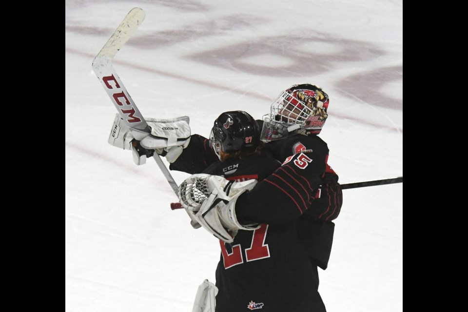 Warriors goaltender Carl Tetachuk celebrates with Jagger Firkus after their shootout win.