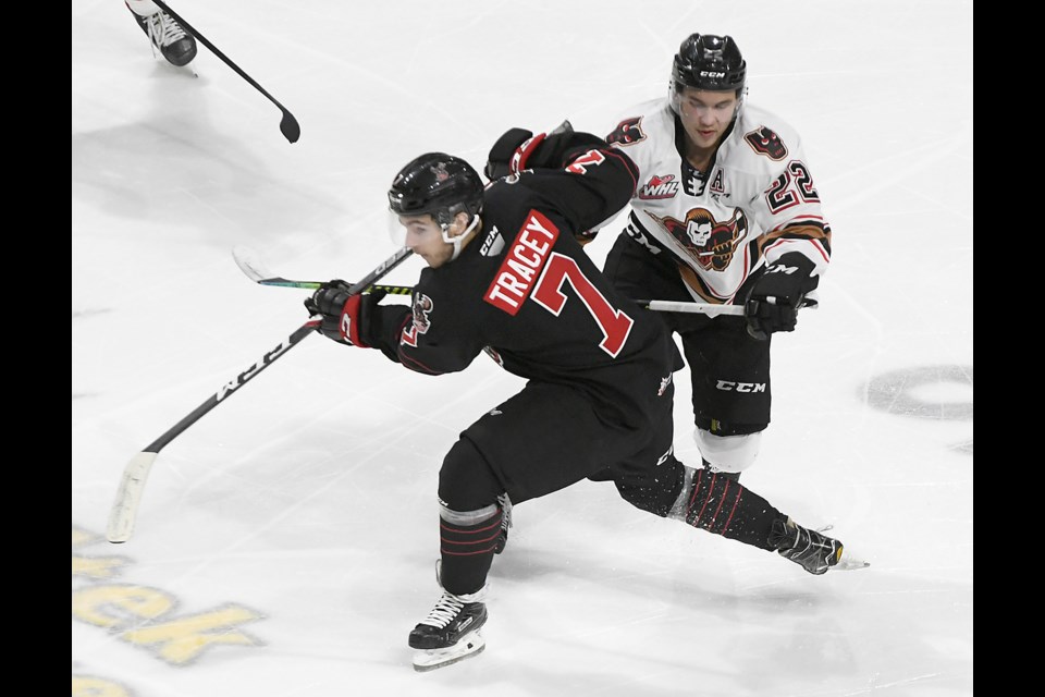 Calgary Hitmen defenceman Jett Woo gives former teammate and fellow NHL draft pick Brayden Tracey a ‘friendly’ tap.