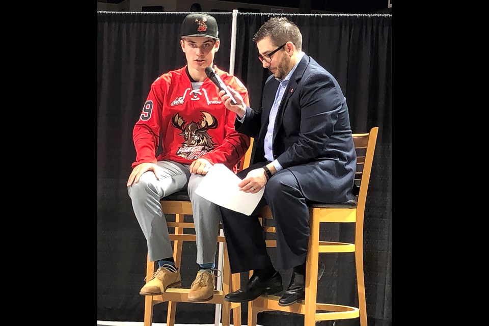 Warriors first round draft pick Denton Mateychuk chats with team director of communications James Gallo after putting on the team’s jersey for the first time.