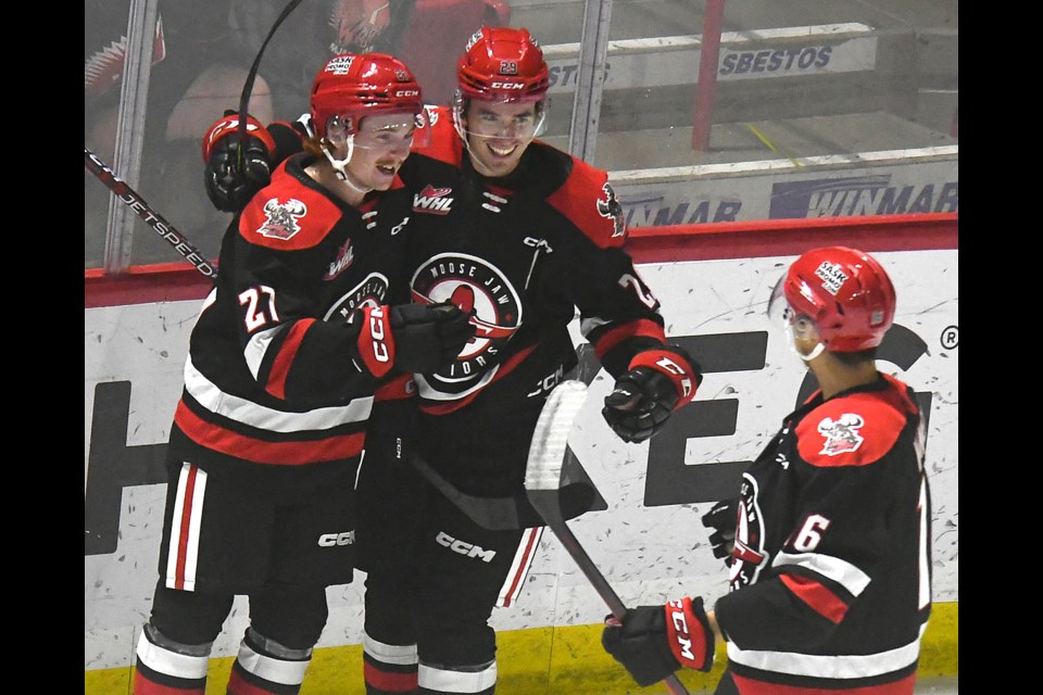 Jagger Firkus and Brayden Yager celebrate the Warriors’ second goal with Max Wanner.