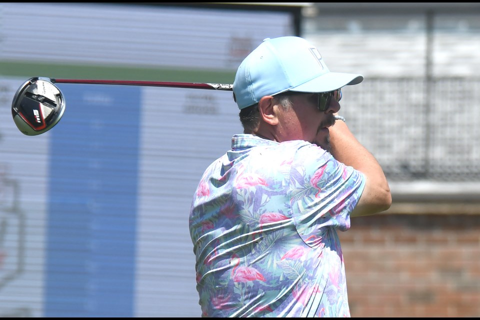 Warriors legend Theoren Fleury tees off on the first hole.