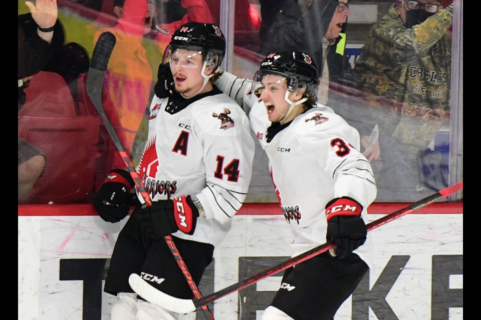 Calder Anderson (left) and Cordel Larson celebrate after Anderson's game-winning goal on Tuesday night.