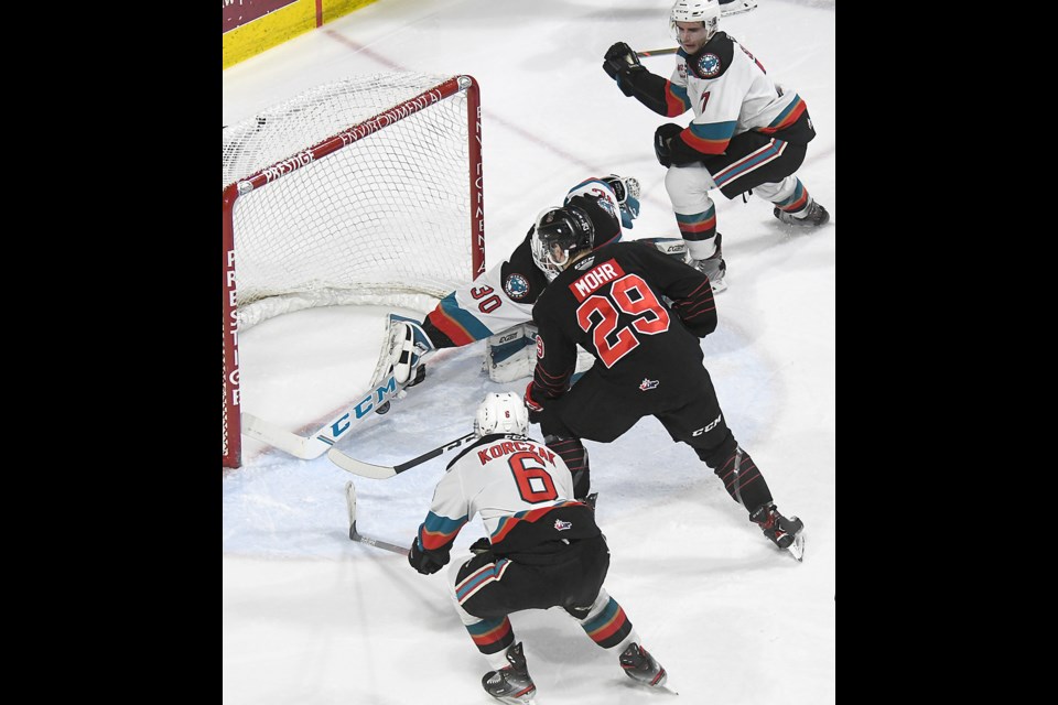 Newest Moose Jaw Warriors defenceman Carson Sass (top) covers the play as former Warrior Kobe Mohr nearly scores against the Kelowna Rockets.

