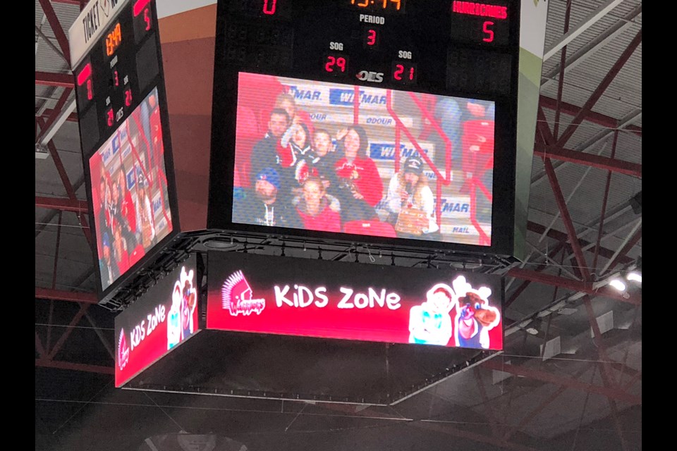 Moose Jaw’s Brandi Kuntz and her family are shown on the scoreboard screen while being honoured by the Fountain Tire 3 Stars program.