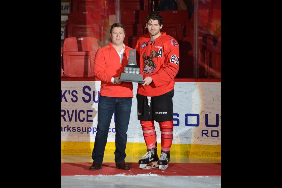 Moose Jaw Warriors forward Tristin Langan receives the Player of the Year award from Warriors president Chad Taylor. (Andy Hamilton Photography)