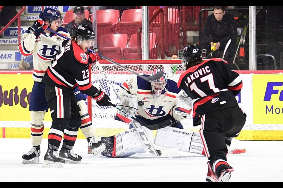 Lynden Lakovic puts a shot on Lethbridge goaltender Bryan Thomson as Atley Calvert looks for the rebound.