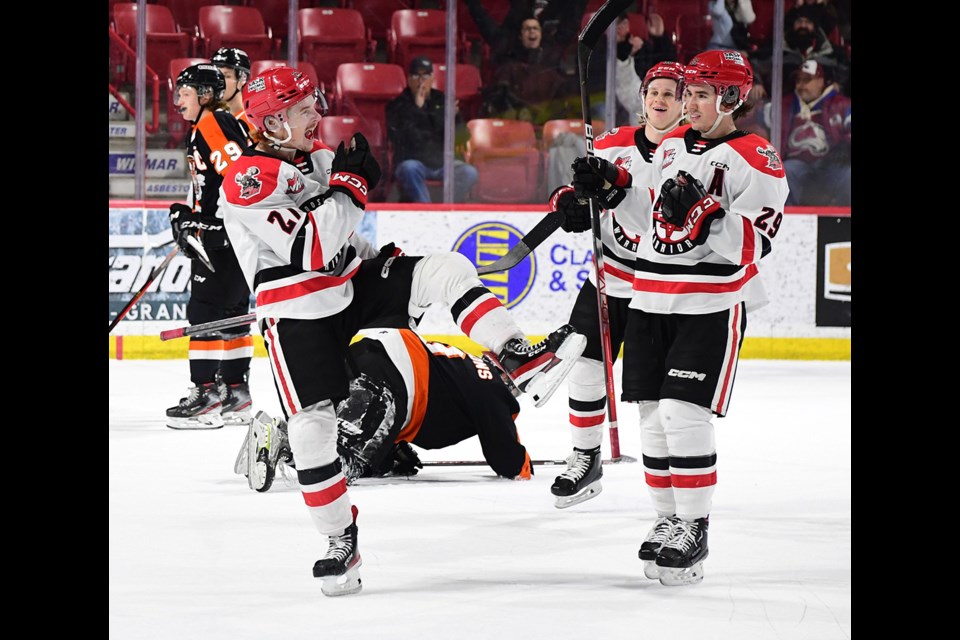 Jagger Firkus celebrates his overtime winner with Brayden Yager and Ryder Korczak.