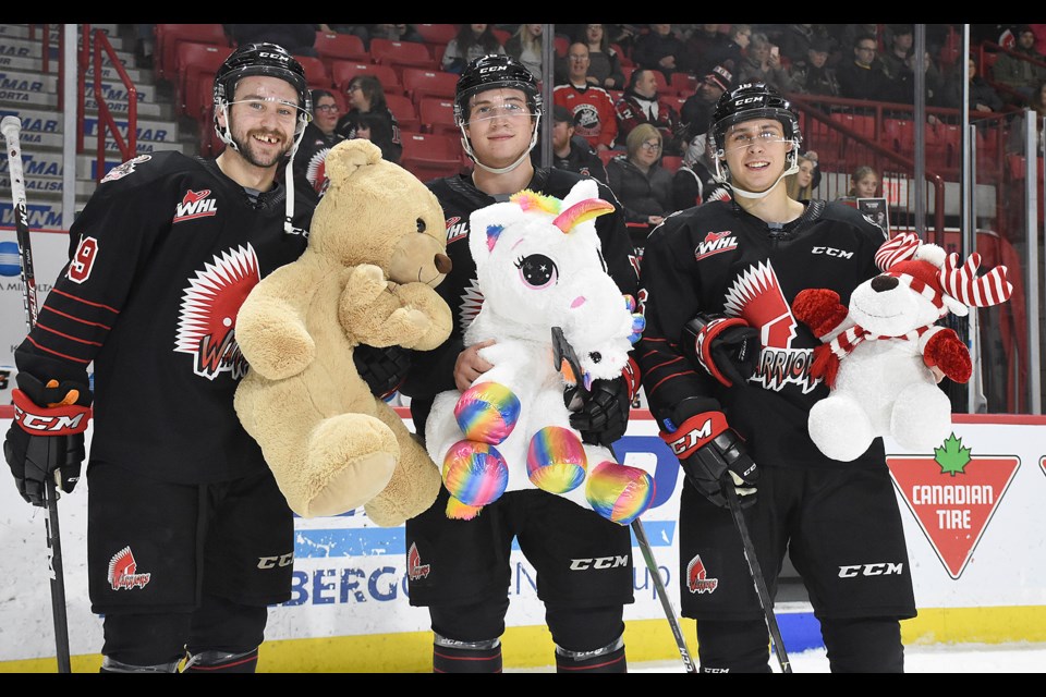 Moose Jaw Warriors 20-year-olds Kobe Mohr, Owen Hardy and Chase Hartje pose with some of the stuffed critters.