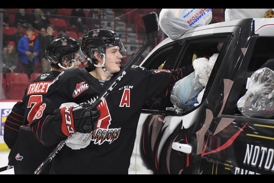 Warriors forward Tate Popple lends a hand with the Teddy Bear Toss in 2019. Popple has put his WHL scholarship to use and is playing at the University of Waterloo this season.