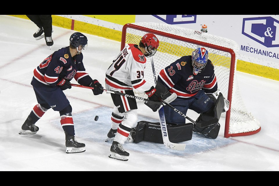 Warriors forward Owen Berge nearly scored on this play but Pats goaltender Drew Sim was able to redirect the puck at the last minute.